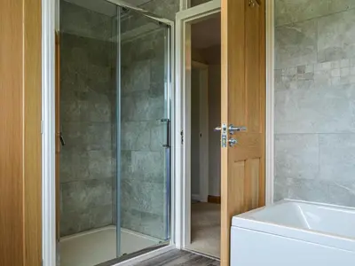 a shower with a glass door in a bathroom at Fell View in Lorton
