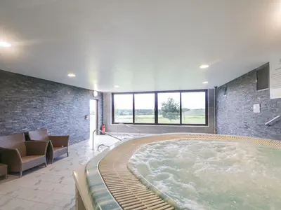 a large hot tub in a room with a couch at Tilly Mint Cottage in Penrith