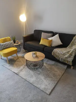 a living room with a couch and a table and chairs at The Mila - Ayr Racecourse - Coorie Doon Stays in Ayr