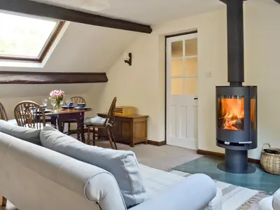 a living room with a couch and a fireplace at The Mill in Mungrisdale