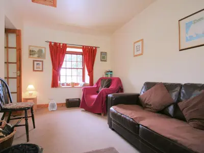 a living room with a couch and a chair at The Smithy - Uk38001 in Kirkcowan