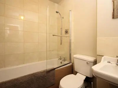 a bathroom with a toilet and a shower and a sink at The Coach House - Uk38000 in Kirkcowan