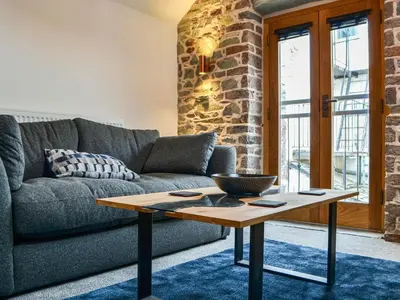 a living room with a couch and a table at The Old Stable in Keswick