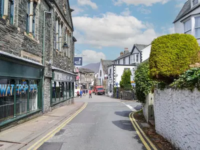 an empty street in a town with buildings at The Old Stable in Keswick