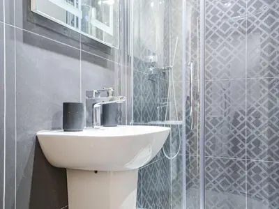a bathroom with a sink and a shower at The Old Stable in Keswick