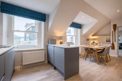a kitchen and dining room with a table and chairs at Howe Keld 6 Second Floor in Keswick