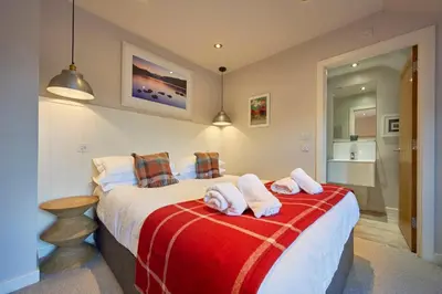 a bedroom with a large bed with towels on it at Howe Keld 6 Second Floor in Keswick