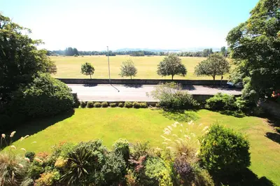 an aerial view of a garden with trees and grass at Beautiful 2 to 3 bed apartment with stunning views! in Ayr