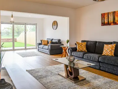 a living room with a couch and a table at Chestnuts in Burgh by Sands