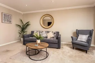 a living room with a couch and a table at London Gate No1 - Donnini Apartments in Kilmarnock