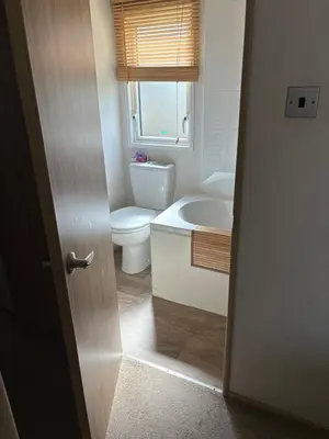 a bathroom with a toilet and a sink at Squirrel Lodge (Unit 7) in Carlisle