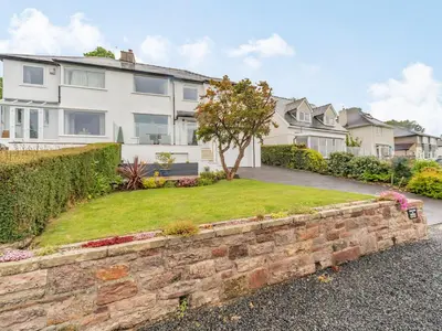 a brick retaining wall in front of a house at Fairview in Keswick