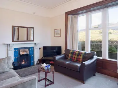 a living room with a couch and a fire place at Yewthwaite Newlands Keswick in Keswick