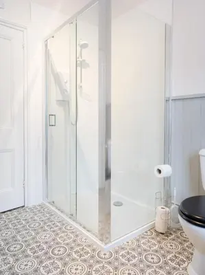 a glass shower in a bathroom with a toilet at Yewthwaite Newlands Keswick in Keswick