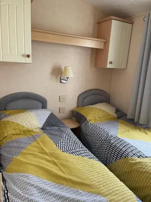 a room with two beds in a room at Beautiful 2-Bed Static caravan in Newton Stewart
