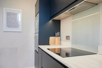 a kitchen with blue walls and a counter at Howe Keld 4 First floor in Keswick