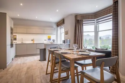 a kitchen and dining room with a table and chairs at Howe Keld 5 First Floor in Keswick