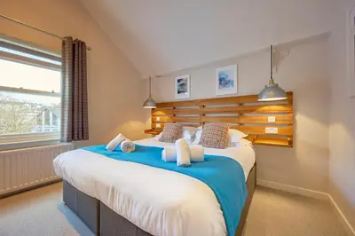 a bedroom with a large bed and a window at Howe Keld 5 First Floor in Keswick
