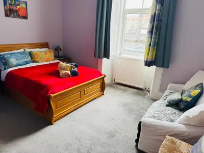 a bedroom with a bed with a teddy bear on it at The Art Bank in Dalbeattie