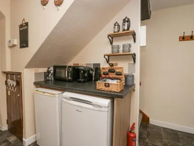 a kitchen with a white refrigerator and a counter at Nook Cottage in Keswick