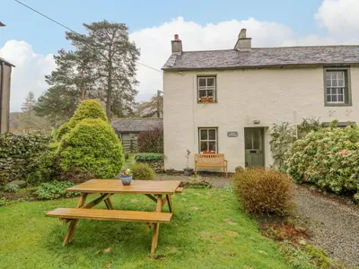 a picnic table in front of a house at Nook Cottage in Keswick