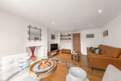a living room with a glass table and a couch at Chaucer's Retreat, Chaucer House, Keswick in Keswick