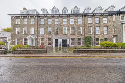 a large brick building on a city street at Chaucer's Retreat, Chaucer House, Keswick in Keswick
