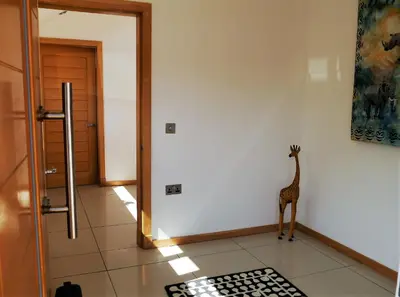 a giraffe statue standing in a room with a door at Annapurna in Portpatrick