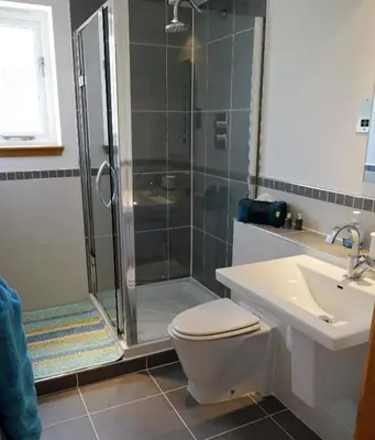 a bathroom with a shower and a toilet and a sink at Annapurna in Portpatrick