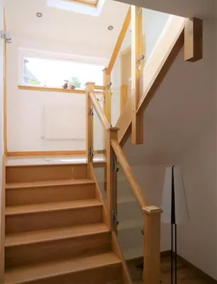 a wooden staircase in a house with a window at Annapurna in Portpatrick