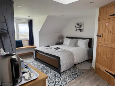 a bedroom with a bed and a tv in a room at Islecroft House Bed & Breakfast in Isle of Whithorn