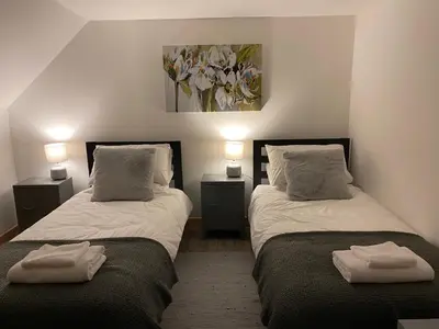 two beds sitting next to each other in a room at Islecroft House Bed & Breakfast in Isle of Whithorn