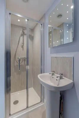 a bathroom with a sink and a shower at Carlton House Portpatrick in Portpatrick