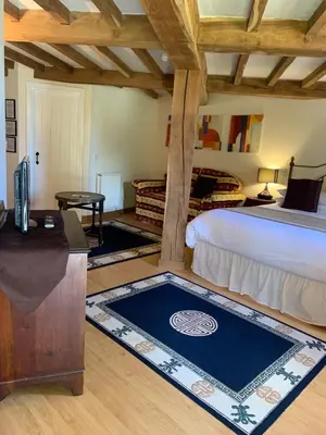 a bedroom with a bed and a desk and a table at Fiddleback Farm in Wigton