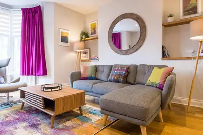 a living room with a couch and a table at Howe Keld 2 Ground Floor in Keswick