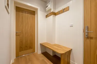 a hallway with a wooden bench next to a door at Howe Keld 2 Ground Floor in Keswick