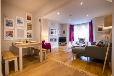 a living room with a couch and a table at Howe Keld 2 Ground Floor in Keswick