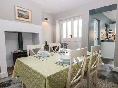 a dining room with a table with a green table cloth at No 2 Waterloo Street in Cockermouth