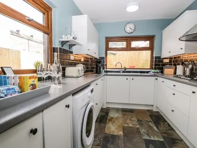 a kitchen with white cabinets and a dishwasher at No 2 Waterloo Street in Cockermouth