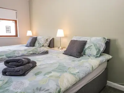 a bedroom with two beds with towels on it at No 2 Waterloo Street in Cockermouth