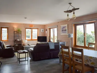 a living room with a couch and a table at Seal Rocks in Lendalfoot