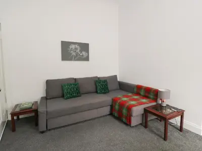 a living room with a couch and a table at Willowbank in Ayr