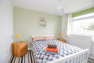 a bedroom with a bed and a window at The Wigwam in Dumfries