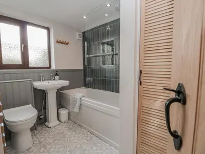 a bathroom with a toilet and a sink and a tub at Ashness in Keswick