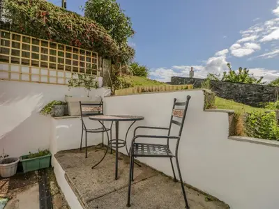 a patio with two chairs and a table at Ashness in Keswick