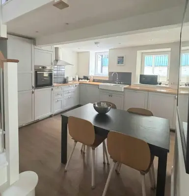 a kitchen with a black table and chairs in it at Holiday House at 22, 3 bedroom cottage in historic Wigtown in Wigtown