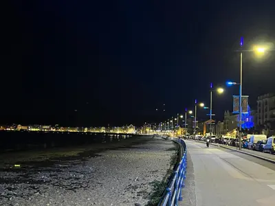 a city street at night with cars parked at Sea-Renity - Self Catering Holiday Let in Douglas