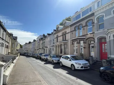 a row of cars parked on a street with buildings at Sea-Renity - Self Catering Holiday Let in Douglas