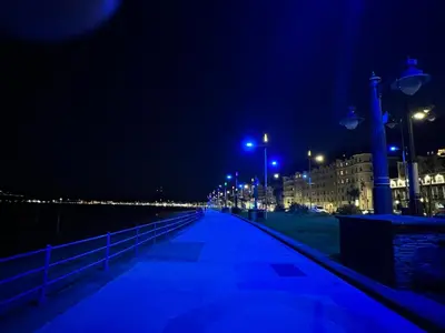 a boardwalk at night with lights on the beach at Sea-Renity - Self Catering Holiday Let in Douglas