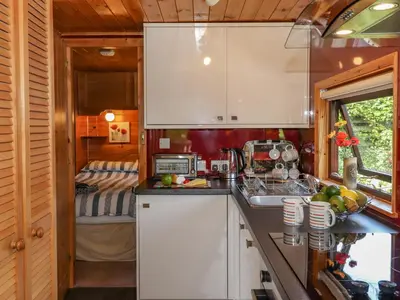 a kitchen with white cabinets and a sink at Robin's Nest in Keswick